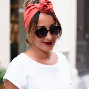 NDJ Occitanie-bandeau-cheveux-Bella-Terra Cotta Modèle femme NDJ Occitanie portant le bandeau cheveux femme Bella noué façon rose africaine en tissu crêpe Georgette de couleur terracotta
